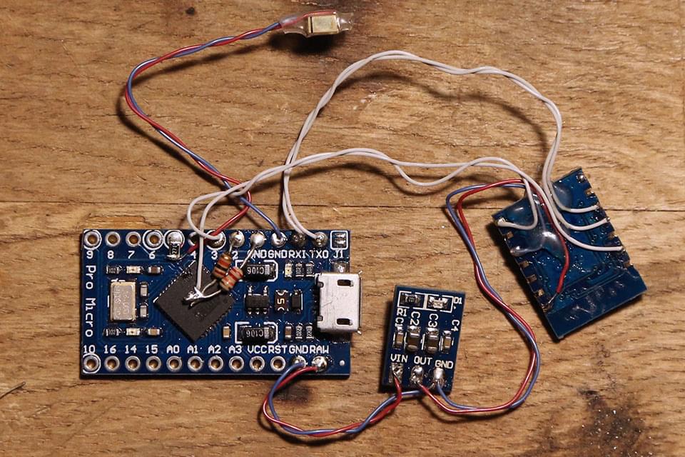 Arduino, ESP-03, 3.3v regulator, and a green status light with 270 ohm resistor on D5